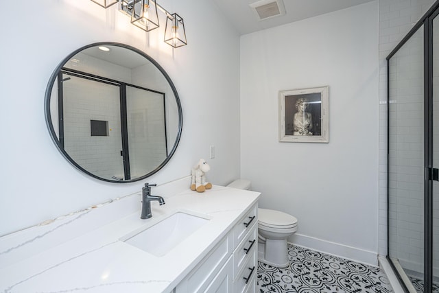 full bath with a shower stall, vanity, tile patterned flooring, and toilet