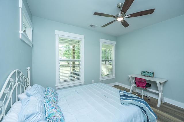 bedroom with wood finished floors, baseboards, and a ceiling fan