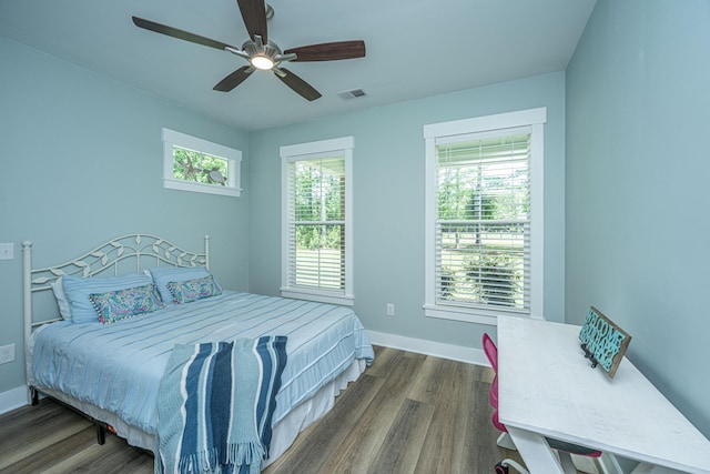bedroom with dark wood-type flooring, baseboards, and a ceiling fan
