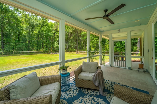 sunroom / solarium featuring a ceiling fan and plenty of natural light