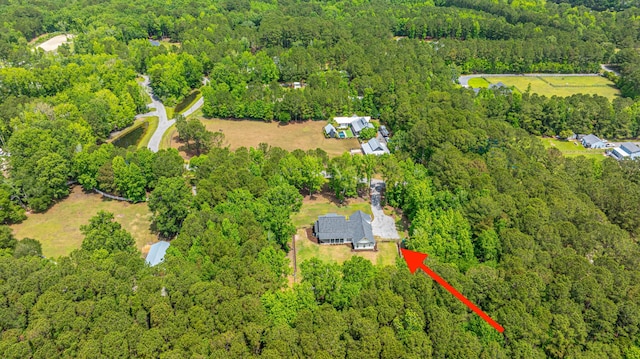 view of property location featuring a forest