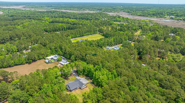 view of property location with a forest