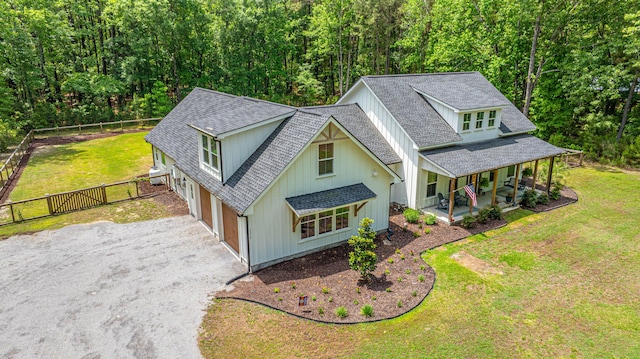 aerial view of property and surrounding area featuring a forest