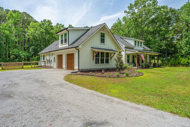 modern farmhouse style home featuring a garage, driveway, a porch, board and batten siding, and a shingled roof