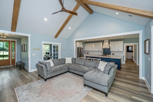 living room with high vaulted ceiling, beamed ceiling, recessed lighting, wood finished floors, and baseboards