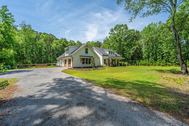 modern farmhouse style home featuring gravel driveway