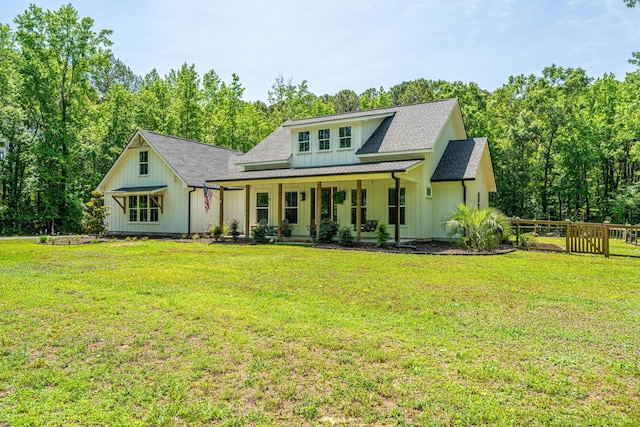 view of front of property featuring covered porch, board and batten siding, and roof with shingles
