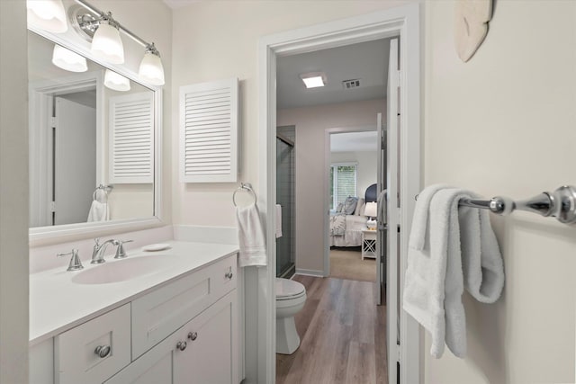 bathroom featuring wood-type flooring, vanity, and toilet