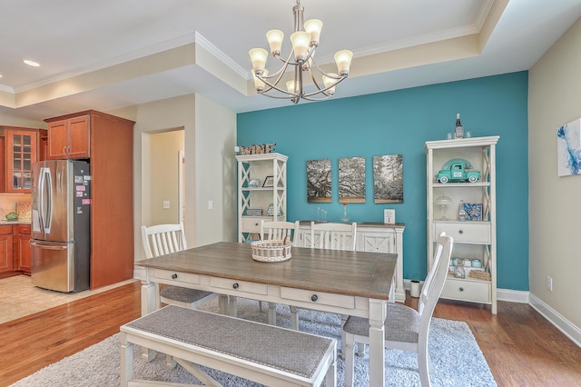 269 Village Stone Cir, Summerville, SC 29483 - dining area featuring a raised ceiling, light wood-style floors, a chandelier, and ornamental molding