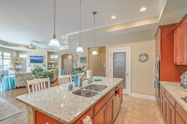 269 Village Stone Cir, Summerville, SC 29483 - kitchen featuring a raised ceiling, ceiling fan, brown cabinets, recessed lighting, and open floor plan
