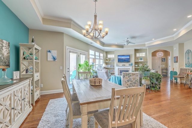 269 Village Stone Cir, Summerville, SC 29483 - dining room with a tray ceiling, crown molding, ceiling fan, a chandelier, and a fireplace