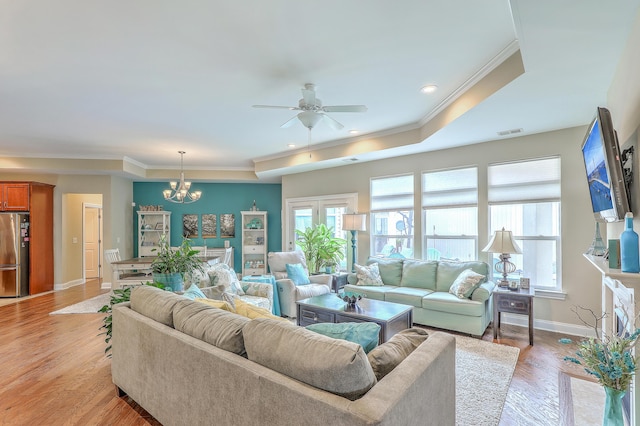 269 Village Stone Cir, Summerville, SC 29483 - living room with a ceiling fan, a raised ceiling, a chandelier, crown molding, and light wood-type flooring