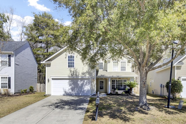 traditional-style home featuring an attached garage and driveway