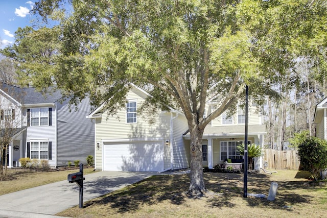 view of front of property with an attached garage, concrete driveway, and fence