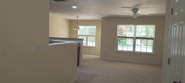 clothes washing area with light carpet and ceiling fan