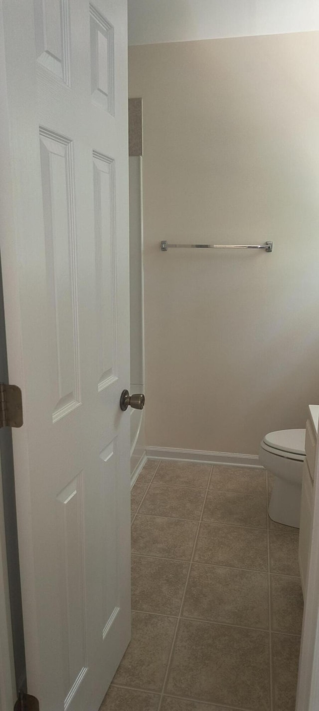 bathroom featuring vanity, toilet, and tile patterned floors