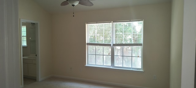 carpeted empty room featuring lofted ceiling and ceiling fan