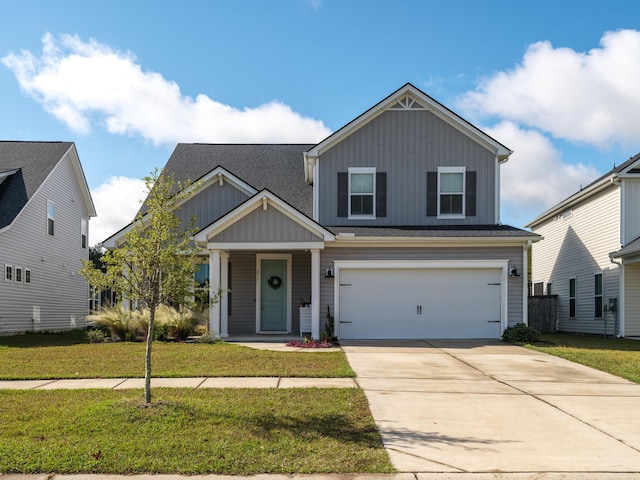 view of front of property featuring a front yard and a garage