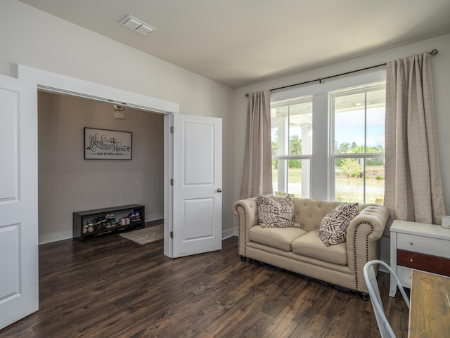 sitting room with dark wood-type flooring