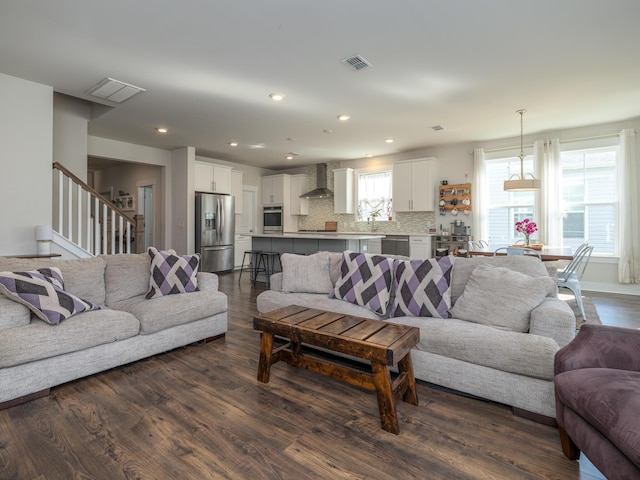 living room with dark hardwood / wood-style flooring and sink