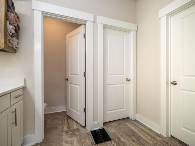 bathroom featuring hardwood / wood-style floors, vanity, and toilet