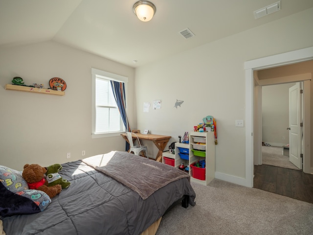 bedroom featuring wood-type flooring and lofted ceiling