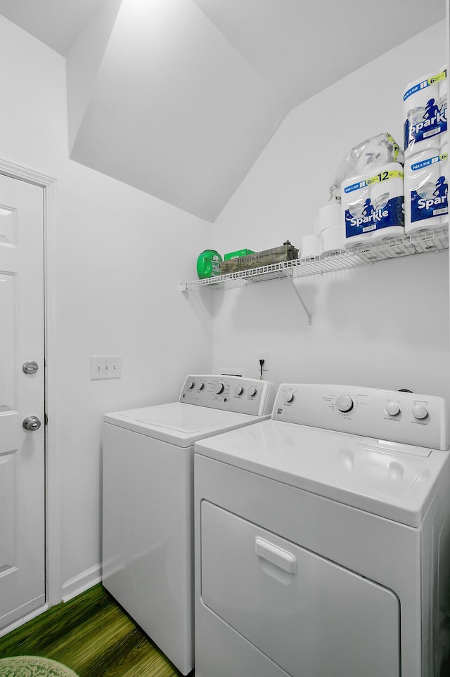 washroom featuring dark wood-type flooring, baseboards, washer and clothes dryer, and laundry area