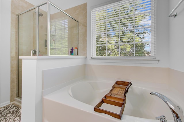 full bathroom featuring a shower stall and a garden tub