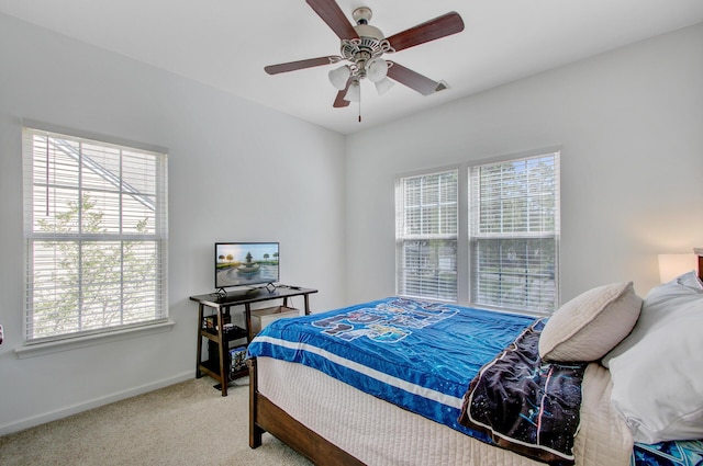 bedroom with baseboards, carpet flooring, ceiling fan, and multiple windows