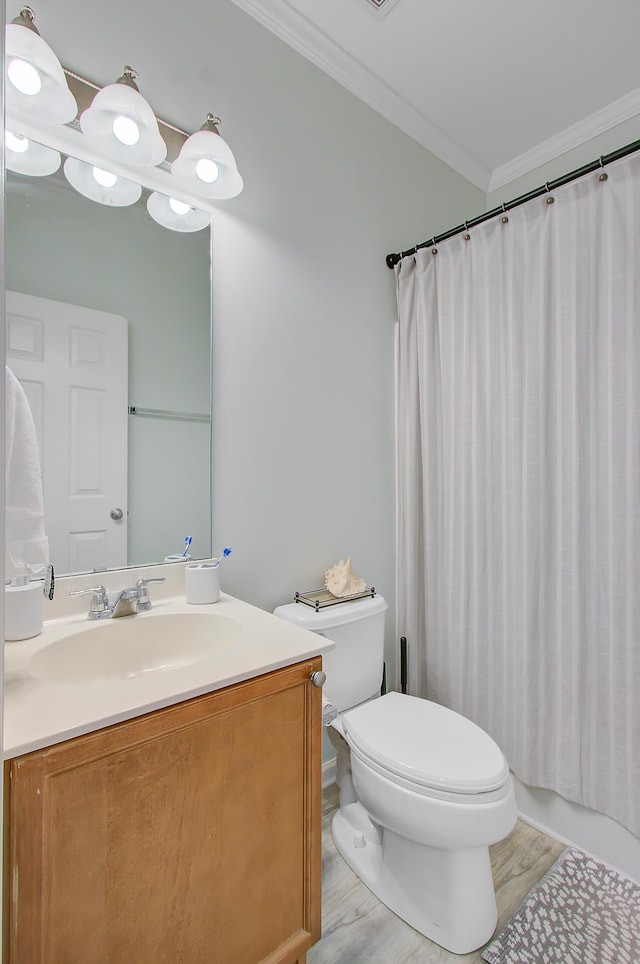 full bath with wood finished floors, toilet, vanity, and ornamental molding