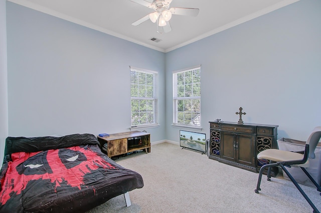 carpeted bedroom with ceiling fan, baseboards, crown molding, and visible vents