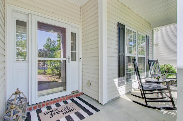 view of exterior entry with covered porch