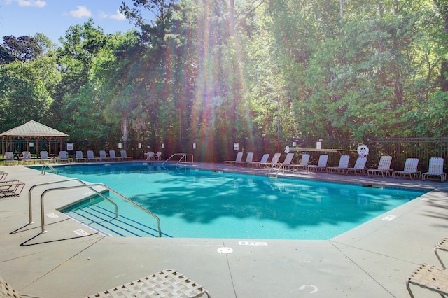pool featuring fence and a patio area