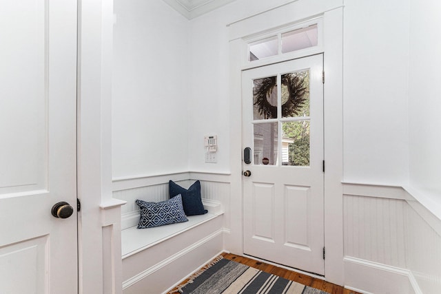 entryway with dark hardwood / wood-style floors and crown molding