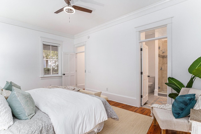 bedroom with hardwood / wood-style flooring, ceiling fan, crown molding, and ensuite bath