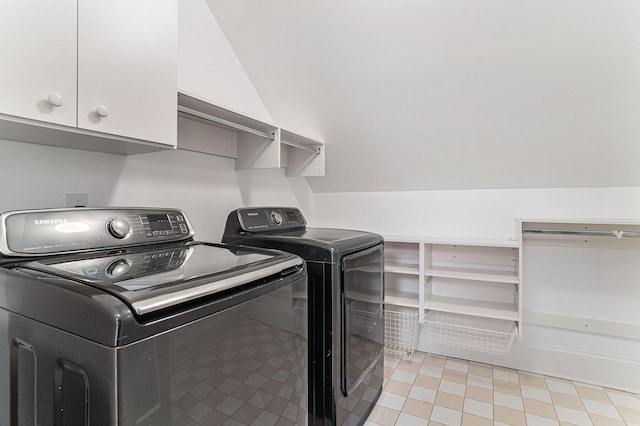 washroom featuring washer and clothes dryer and cabinets