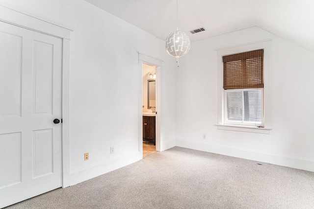 interior space with light colored carpet and lofted ceiling