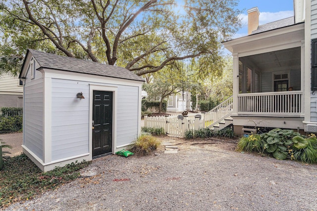 view of outdoor structure with a sunroom