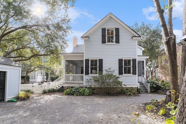 back of house featuring a sunroom