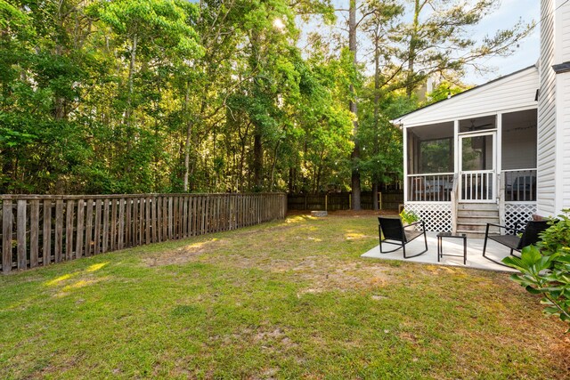 1971 N Smokerise Way, Mount Pleasant, SC 29466 - view of yard featuring a fenced backyard, a patio, and a sunroom