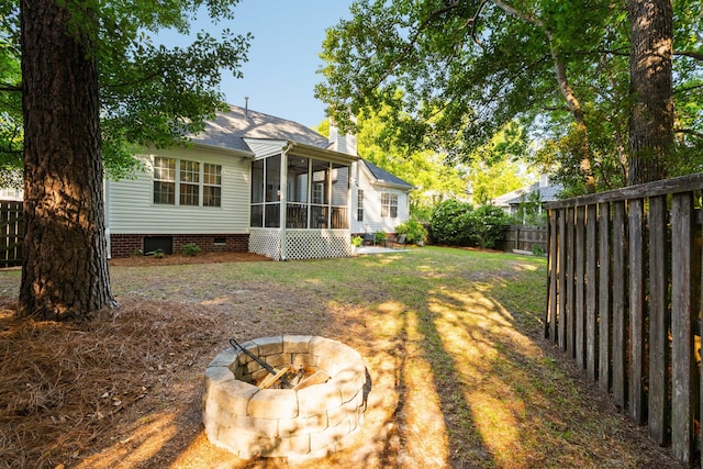 1971 N Smokerise Way, Mount Pleasant, SC 29466 - view of yard with a sunroom, a fenced backyard, and an outdoor fire pit