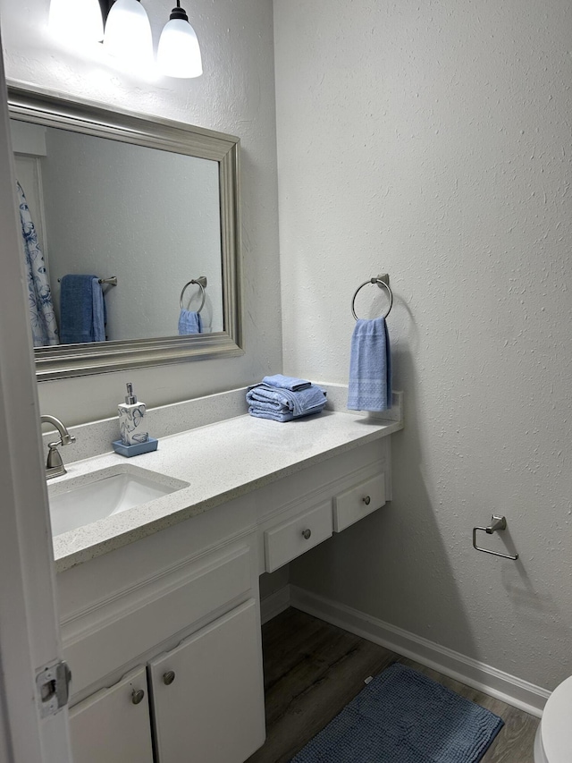 bathroom featuring hardwood / wood-style flooring and vanity