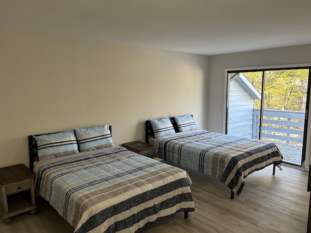 bedroom featuring hardwood / wood-style flooring and access to exterior