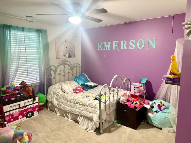 carpeted bedroom with ceiling fan and multiple windows