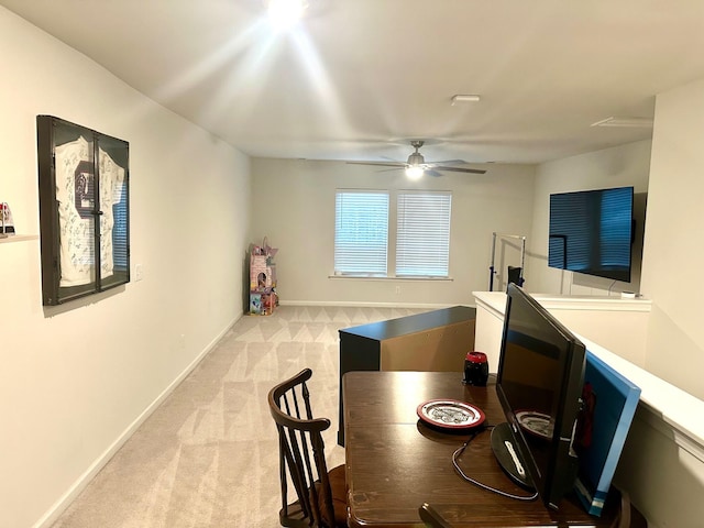 carpeted dining area featuring ceiling fan