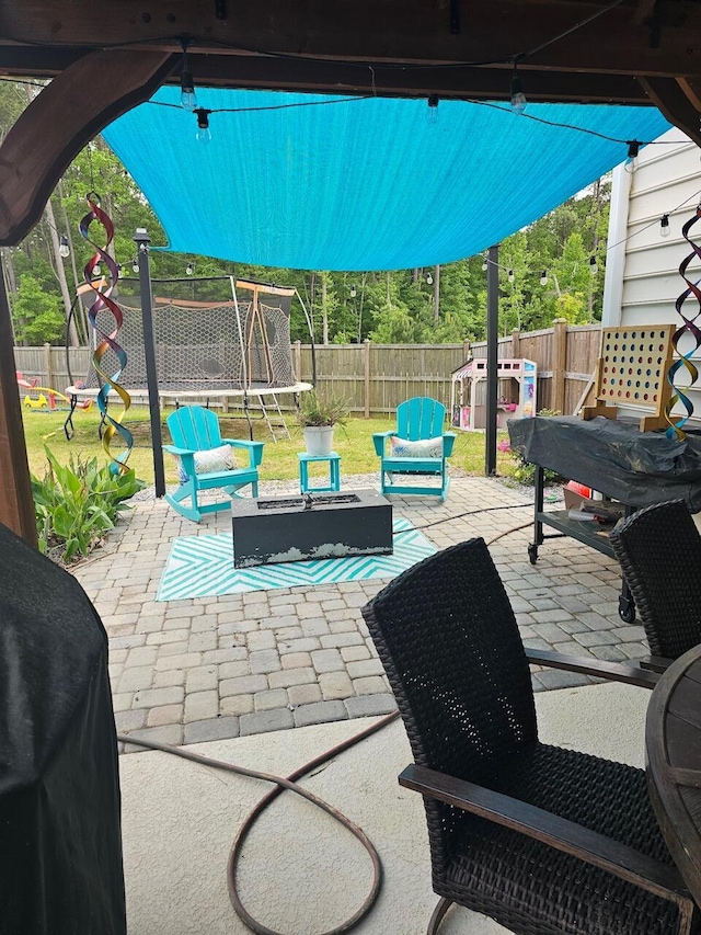 view of patio featuring a playground and a trampoline