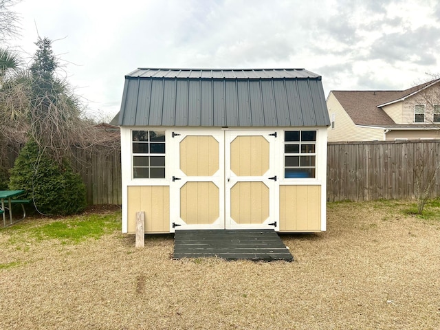 view of outbuilding featuring a lawn