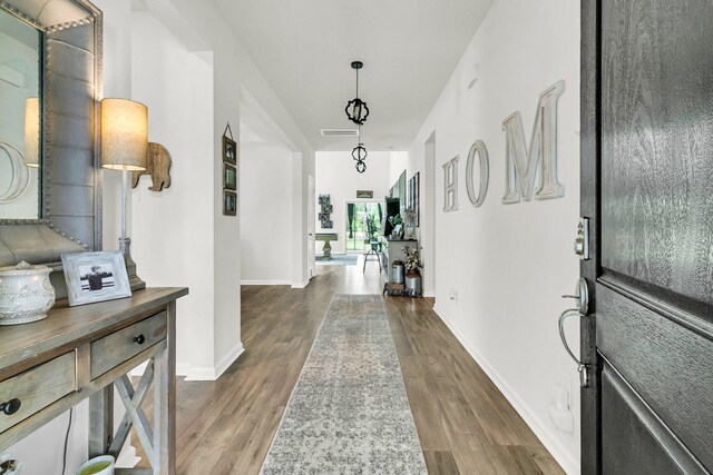 corridor featuring dark wood-type flooring