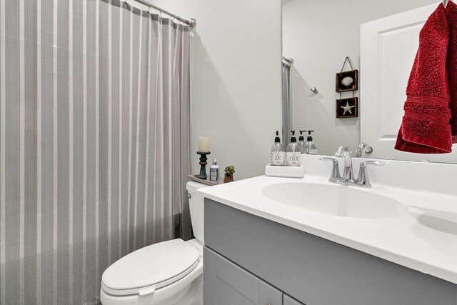 bathroom with toilet and vanity