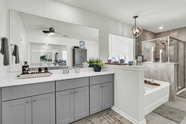 bathroom with ceiling fan with notable chandelier, shower with separate bathtub, tile patterned floors, and vanity